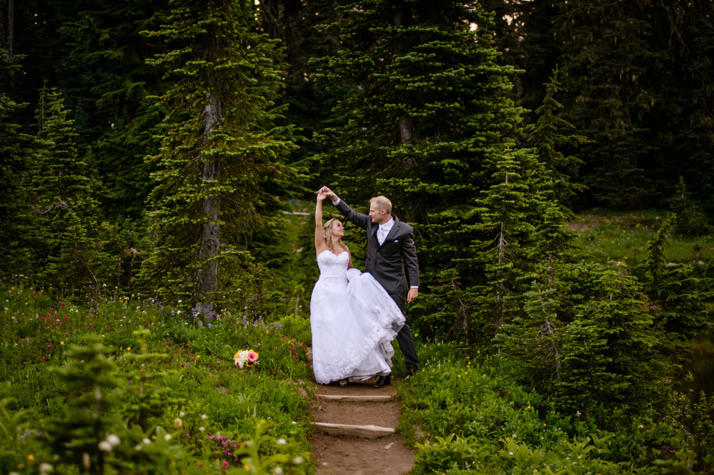 Bride and groom dancing in the woods