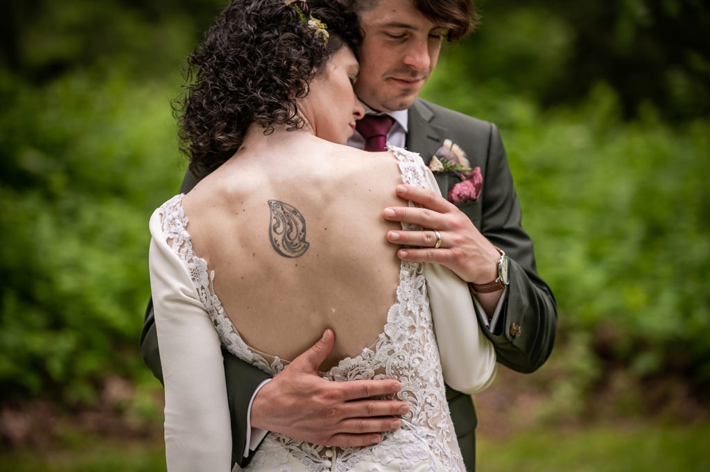 Bride's tattoo and groom's hands