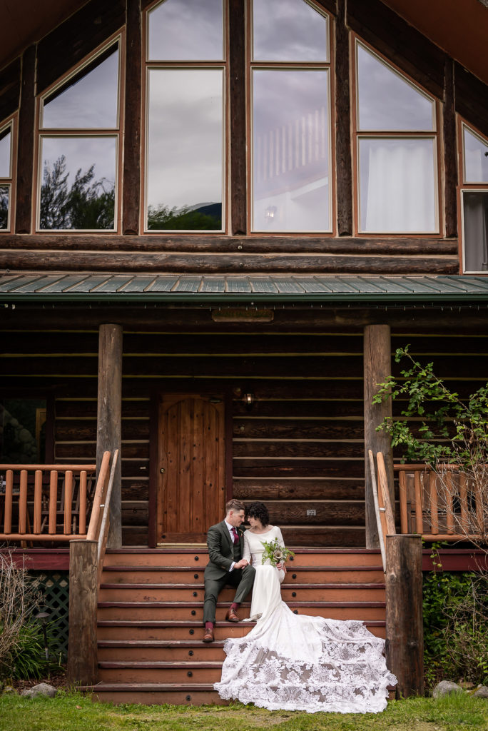 Bride and groom on porch at Wallace Falls Lodge wedding