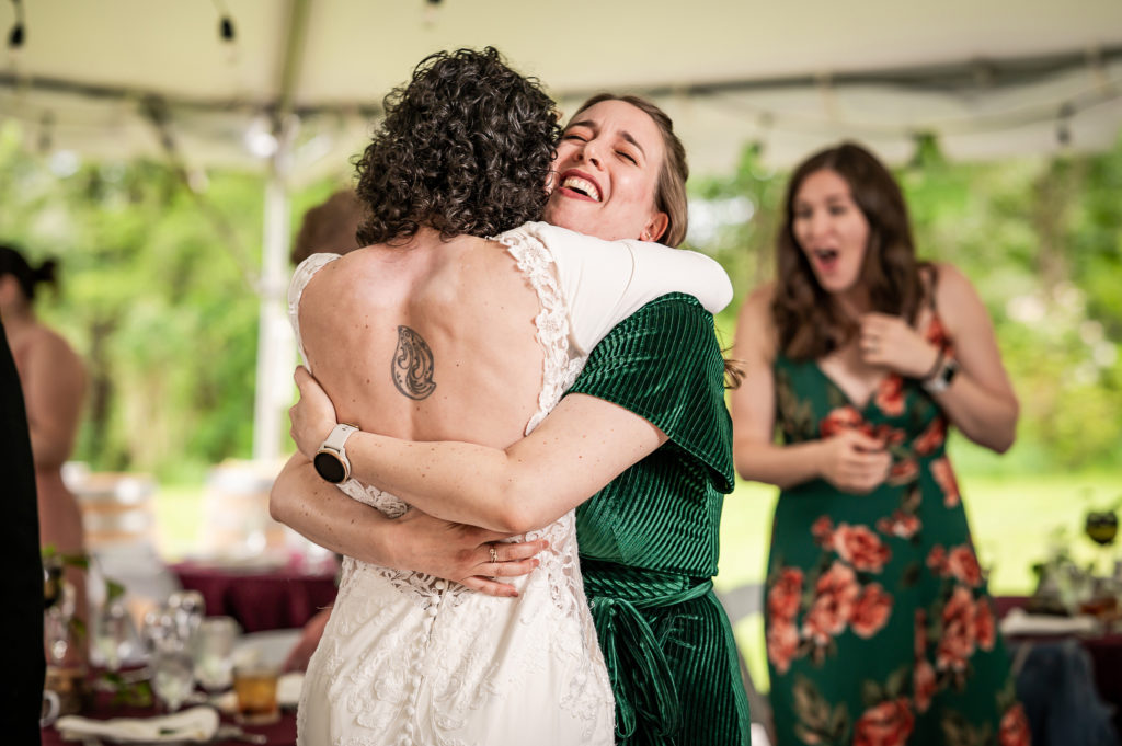 Bride hugging friend