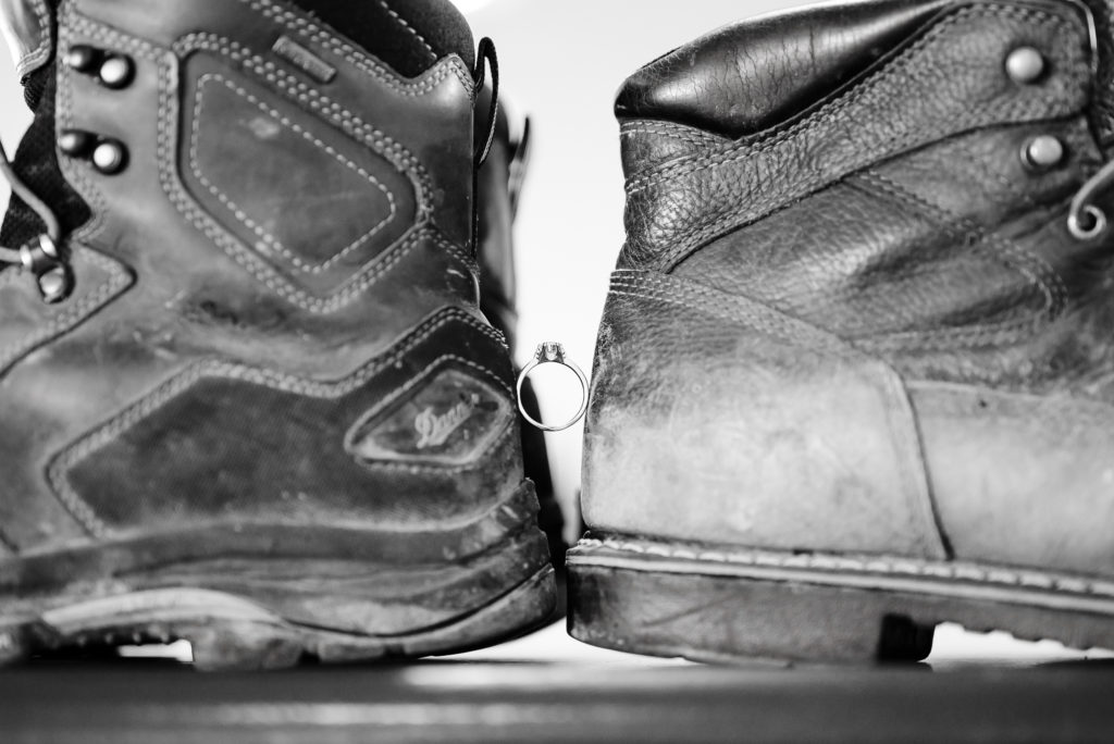 Detail of wedding ring and work boots