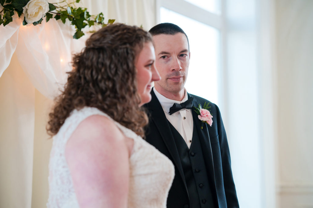 Groom looks at bride during Union Club Tacoma wedding ceremony