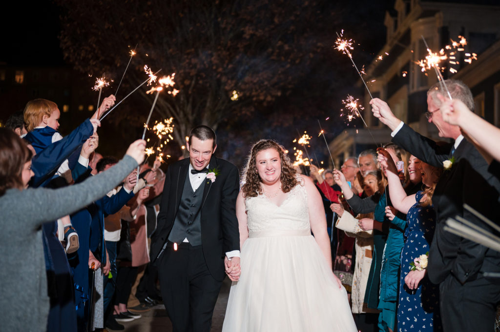 Bride and groom smiling with sparklers at Union Club Tacoma wedding